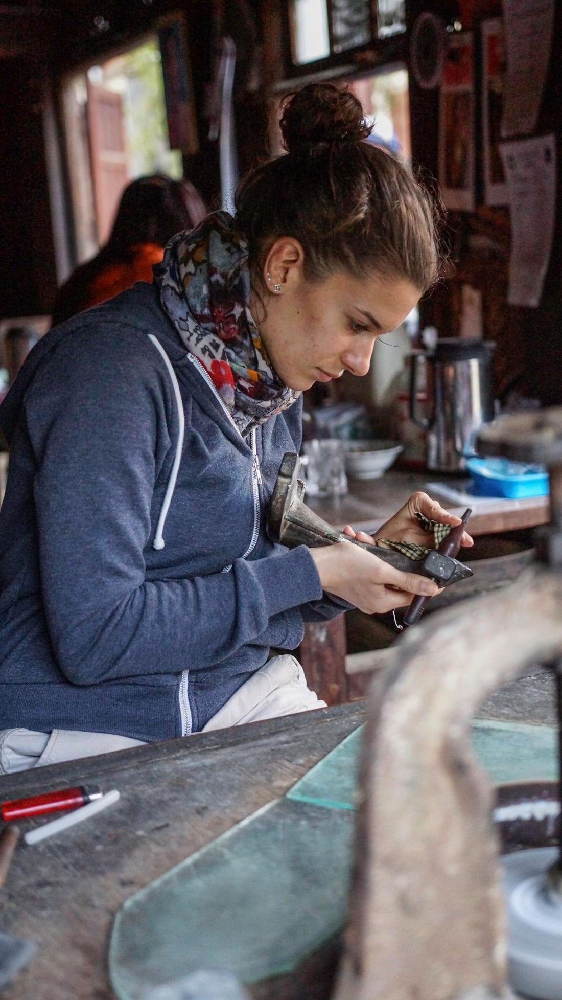 Victoria Raynaud cutting a gemstone using a traditional machine from Burma